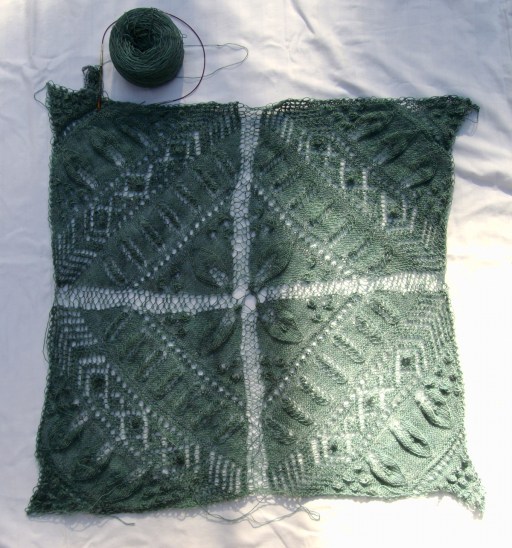 See the hot tensioning mess that is the stitching between the squares? See how I'm knitting the border on in violation of the pattern directions? These things are not unrelated.