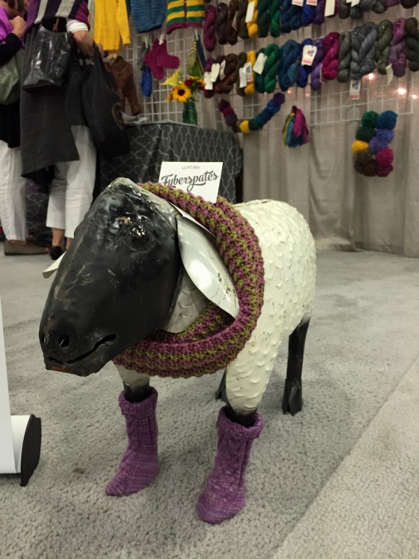 At the Fyberspates booth. Metalwork sheep + wee hand knit socks? I'm in love.