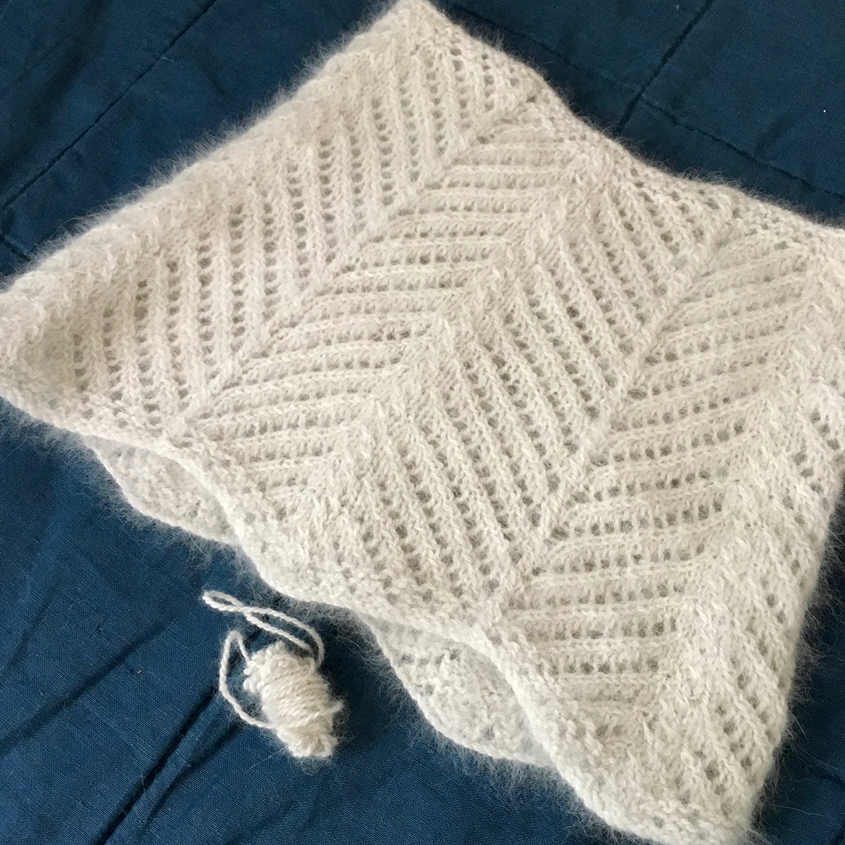 Qiviut cowl finished and blocked, with a tiny ball of leftover yarn.