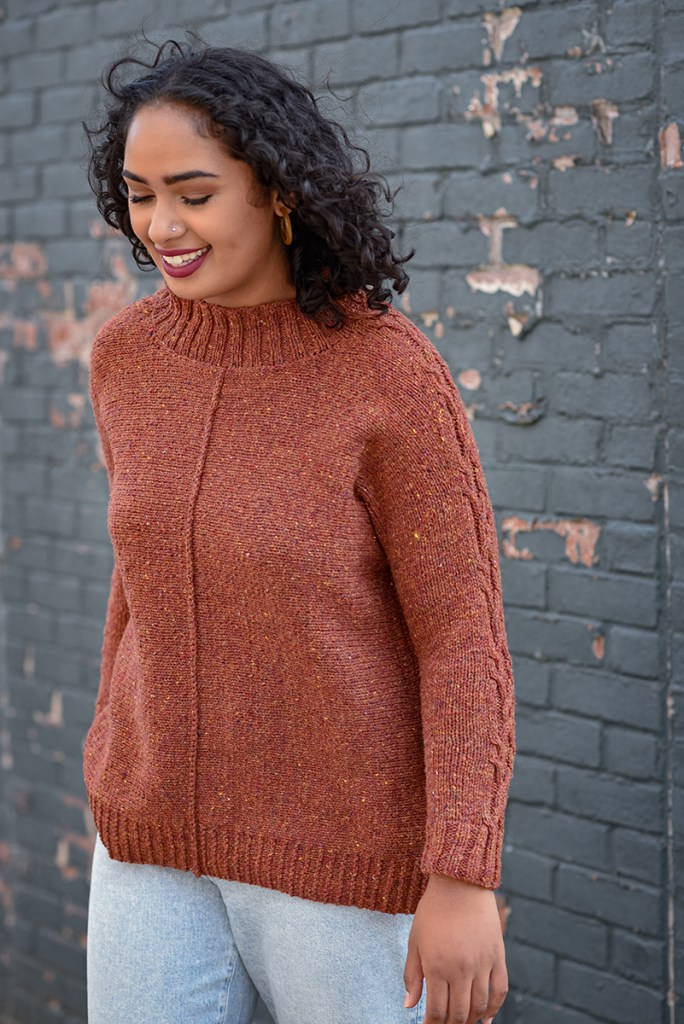Front view of a woman wearing a hand knit pullover.